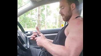 Muscle guy jerking off inside a car in forrest public place 