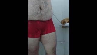 Fat man taking a shower in red underwear