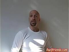 Muscular bald stud Anthony teasing and playing with his feet