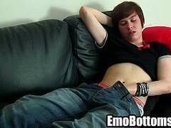 A sexy brunette emo twink is jerking his cock off