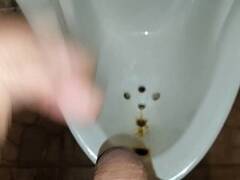 Postsex public urinal piss viewed between legs