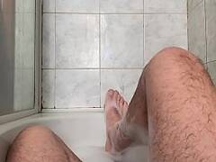 24 year old in the bathtub playing with her feet and cock
