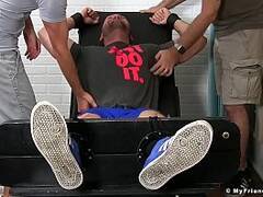 Julian Knowles is restrained and tickled by two kinky studs