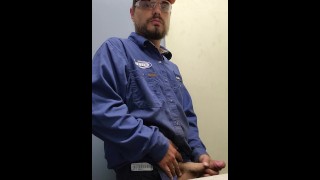 Blue collar worker strokes cock on the clock