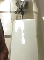 Tattooed guy gets hard at urinal and shows off his